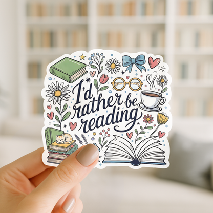 Sticker with 'I'd rather be reading' text held by a hand in front of a blurred bookshelf.